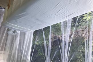 bed in outdoor covered with nets