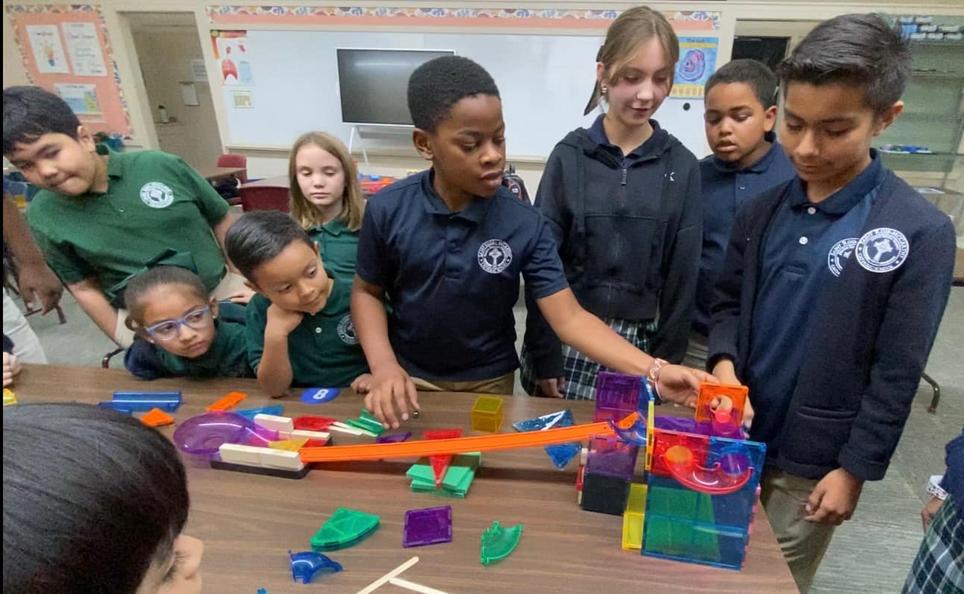 Hanford Catholic School Students collaborating on a science project.