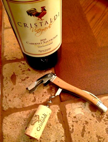 Wine bottle and corkscrew on table