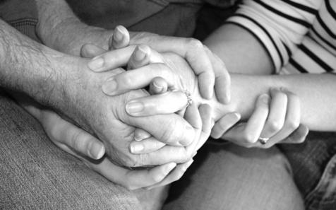 Holding hands grieving after family member dies