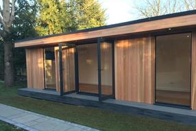 Large modern garden room with gym, storage shed, toilet and pergola area in Gidea Park, Essex built by Robertson Garden Rooms