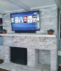 After picture of TV Mounted on Brick Fireplace with components installed.  Carolina Custom Mounts in Charlotte nc. Best TV Mounting Service