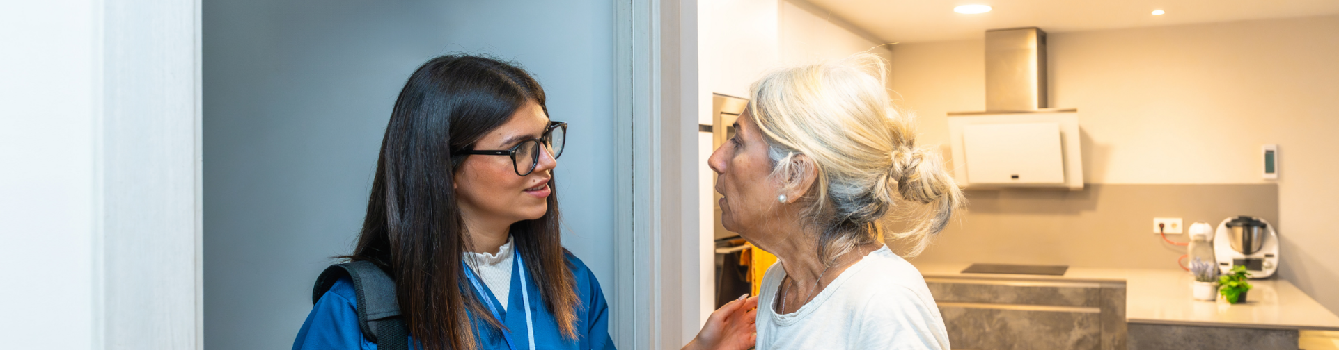 Nurse speaking to elderly patient about care and services