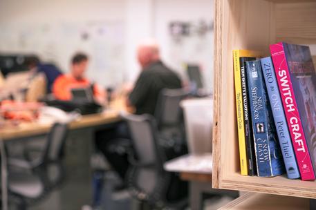 stack of books in library with startup acclelerator background