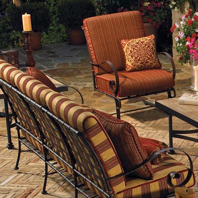 OW Lee sofa seat with orange and cocoa striped fabric cushions.