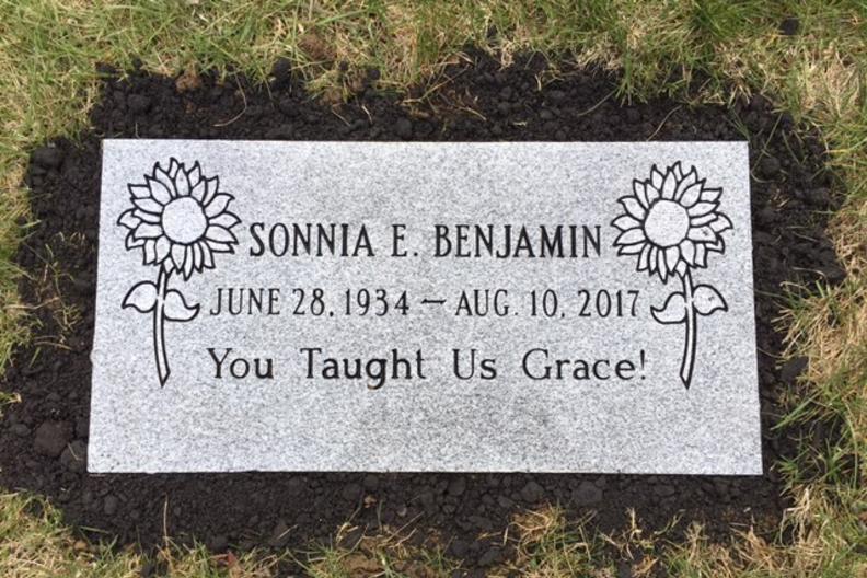 flat tombstone with sunflower designs