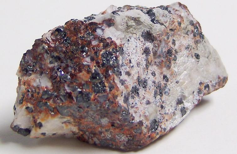Black Franklinite, red Zincite, white Hydrozincite, green fluorescent Willemite, white Calcite - Sterling Mine, Sterling Hill, Ogdensburg, Franklin Mining District, Sussex County, New Jersey, USA