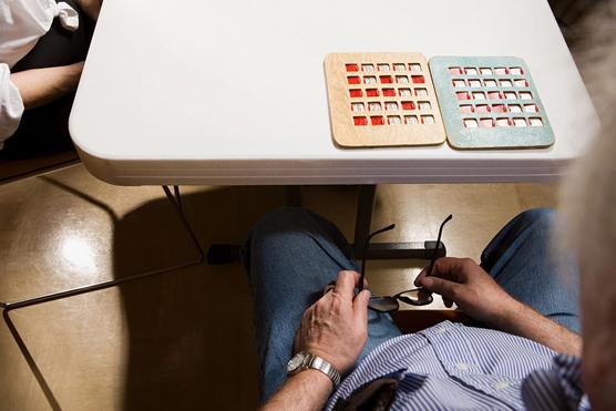 Elderly senior playing bingo alone