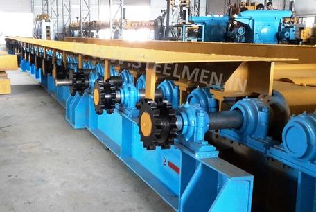 Y-TABLE FOR ROLLING MILLS, OIL LUBRICATION SYSTEM (Capacity - 50 LPM to 300 LPM), AUTOMATIC BUNDLING MACHINE, Hot Billet Shear, Billet Charging Grate, Flywheel, Gear Boxes, Mill Stands, Shearing Machines, Conveyor Rolls, Spindle Carrier, Pinch Rolls, Tilting Tables, Twin Channel, TMT Quenching System, Tail Breaker Pinch Rolls, Oil Lubrication System, Guide Box & Twist Pipes Mechanical Pusher, Mill Accessories, TMT Chain Transfer System, Recuperators, Cooling Tower, gear coupling, universal spindles, steel rolling mill, rolling mill items, steel plant machineries, steel plants, CCM, Continuous casting machine, steel melting, steel makers, leju Thomas, 9310524787, Gear boxes, Pinion stands, Rolling mill Stands on Fiber& bearings, Roller tables, Tilting tables, Y tables, Guide boxes, Chocks, Couplings, Spindles, Rotary shears, Flying shears, Cantilever type pinch Rolls, Tail Breaker pinch Rolls, Quenching Systems (for 8-16 mm, 16-25 mm, & 25-32 mm), Twin channel, Hot Rolling Mills, Shears, Automatic Cooling Bed, Quenching Boxes, Twin Channel Machine, Mill Stands, Cold Rolling Mills, Gear Couplings, Industrial Gear Box, Punching Cropping Machine, Hot Saw, Transmission Tower Machinery, Chain Transfer Systems, Product Design Development, Hot Rolling Mills Bar Rolling Mill Hot Rolling Mill Equipment Slit Rolling Mill Shears Flying Shear Crank Shear Continuous Rotating Shear Disc & Drum Shear Automatic Cooling Bed Quenching Boxes TMT Quenching Boxes Twin Channel Machine Industrial Gear Box Helical Gear Box Rolling Mill Gear Boxes Mill Stands Rolling Mill Stands TMT Mill Stands Housingless Mill Stands Cold Rolling Mills Gear Couplings Gear Jobwork Punching Cropping Machine Hot Saw Traveling type Hot Saw Fixed type Hot Saw Transmission Tower Machinery Chain Transfer Systems Product Design Development, Turnkey Solutions For Hot Rolling Mills Coilers Mill stands Shears & hot saws Twin channel Cooling beds Gear boxes & pinion stands TMT Equipment, Rolling Mill Machines Blade Grinding Machine Hot Saw Machines Straightening Machine Hydraulic Pusher, Hydraulic Cylinders, Ejectors, Hot Rolling Mill Flywheels Gear Boxes Mill Stands Gear Couplings Material Handling Equipment TMT Equipment Cooling Bed Shearing Machines Straightening Machines Spare Parts Of Rolling Mills Other Allied Equipments Bending & Time Machine Workshop Machinery, ♦ Bar Mills ♦ Structural Steel Mill Wire Rod Mill with Bar in Coil Line Rolling Mill for High-Grade Steels Section Mill High Speed Laying Head with Gear Box Crank Lever Shears Crank Shears Housingless Stands Double Crank Shears Rake Type Cooling Conventional Mill Stands Gear Boxes Rod mill block Varioblock Flying Shear • Tail Braking Pinch Roll • Cold Shear, Starting Stock Billets 160 x 160 x 12,000 mm 130 x 130 x 12,000 mm Furnace Group Charging grate, Hot charging, Elevator, Induction online heater Finished product Rebar 8 three-strand slit TMT Rebar 10 two-strand slit TMT Rebar 12-40 mm TMT Flats, angles and channels are possible too Sub-bundles 100-400 kg Master bundles 1 MT-3 MT Furnace Capacity 80 MT/h Main train Single-strand H/V arrangement, two strands are H/V type Roughing train : 4 off Model 600, 2 off Model 440, Free outlet after stand # 2 Intermediate train : 4 off Model 440, 4 off Model 340 Finishing train : 6 x Model 340 Associated shears Loopers : 8 off vertical, 6 off Single strand, 2 off multi strand Capacity 400,000 MT/y Cooling bed group Water quenching line, Thermex Cooling bed shear Cooling bed 66 x 10 m Finished speed 16 m/s (20 m/s) Material grades Carbon steels, Alloyed Structural Steel grades Continuous finishing shop Stationary cold shear 3,000 kN Counting system Small bundle forming 4 off Tying machine Various associated equipment, e.g. stoppers, chain transfers, roller tables, Starting stock Blooms 180 x 180 x 8,000 - 12,000 mm 300 x 300 x 8,000 - 12,000 mm Finished product Rebars 28 - 40 mm Rounds 30 - 100 mm dia. Hexagons 50 - 80 mm Flats 8 x 30 - 60 x 150 H-Beams 100 - 180 mm I-Beams 100 - 200 mm T-sections 75 - 140 mm Channels 100 - 200 mm Angles 80 x 80 x - 200 x 200 mm U-type sections for mine timbering 18U, 25U,29U Bundle/stack length 6 - 24 m Bundle/stack weight 2 - 5 t Furnace capacity 116/143 t/h Annual capacity 700,000 t/y Finishing speeds 6 m/s Material grades Carbon steels, Alloyed structural steel,Antifriction bearing steel Furnace group: Elevator (for hot charging), charging grate,weighscale, descaler, insulated holding tunnel Mill train: Single strand Roughing train 4 x Model 670, 1 x Model 760(V-H-HV-H) Intermediate train: 2 x Model 760, 4 x Model 670(H-H-H-UR-UR-HV) Finishing train: 5 x Model 670 (UR-HV-UR-HV-FUR) Associated shears Loopers: 4 x vertical Cooling bed group: Water cooling line, pinch roll unit Cooling bed shear Cooling bed 84 x 19 m Short-bar collecting device Continuous finishing shop In-line straightening machine (10 rollers) Hot saws: 1 x stationary, 1 x movable Abrasive cutting machines: 1 x fixed, 1 x movable Piling and stacking facilities (magnet-type) Tying machines: 2 x stationary, 2 x movable Various associated equipment, e.g. stoppers, chain transfers, roller tables. upto 150 x 150 x 12,000 mm Finished product: Wire rod 5.5 - 16 mm Rebars Nos. 3, 4 and 5 (as per ASTM) Coils 16 - 42 mm dia. Furnace capacity: 70 t/h Annual capacity: 300,000 t/y Finishing speeds: Wire rod line - 100 (120) m/s Bar in coil line - 13.5 m/s Material grades: Cold-heading steels Reinforcing steels Steels with a carbon content from low to medium Piano-wire PC-wire Free-cutting steel Water cooling line, pinch roll units, bar reels (2x), coil transfer,chain conveyor with retarded and accelerated cooling facilities, transfer unit to Power & Free coil handling system, Starting stock Billets 50 x 100 x 10,000 mm 125 x 125 x 11,400 mm Finished product Rod 5.5 - 13.5 mm dia. Bars 11 - 57 mm dia. Flads 22 - 120 mm, 5 - 12 mm thick Bundle/stack length 3 - 8.5 m Bundle/stack weight 0.5 - 3 (5) t Furnace capacity up to 60 t/h Material grades High-grade structural steels 34 Cr 4, 60 SiMn7, 42 CrMo4 Antifriction bearing steels 100 Cr 6, 100 Cr 2, 100 CrMo 7 3 Material grades Tool steels X 210 Cr 12, X 38 CrMoV 5 1, 55 CrNiMoVS 4 2 4 Acid-resistant and heat-resistant steels X 5 CrNiMo 18 11, X 2 CrNiMo 19 13,X 20 CrNiSi 25 4 High-speed steels X 79 Wco 18 5, X 82 W Mo 6 5 5 Special alloys X 55 CrMnNiN 20 8,X 45 CrSi 9 3 X 3 CrNiMoNbN 23 17 The complete range of steel grades includes approx. 300 different grades Furnace group: Charging grate, cross transfers, weighscale, descaler (2x), heatholding tunnel Mill train: Single strand, H/V - arrangement Roughing train: PSW and 6 x Model 440 Intermediate train: 4 x Model 440, 2 x Model 340 Finishing train: 4 x Model 340 Kocks-block 8-stand wire rod block for high grade steels 3 x 215/ 5 x 170 Associated shears Loopers: 7 x vertical, 1 x horizontal Cooling bed group: Water cooling line, pinch roll unit Cooling bed shear Cooling bed 57 x 5 m Continuous finishing shop: Abrasive cutting machine Piling and stacking facilities (non-magnet type) Tying machines: 1 x fi xed, 1 x movable various associated equipment, e.g. stoppers, chain transfers, roller tables etc. Rod finishing equipment: Water cooling and equalizing sections, pinch roll unit,laying head Ring conveyor for retarded and accelerated cooling reforming tub Pallet-type coil handling system, compacting & tying units,weighscale, unloading station Reel plant Water cooling and equalizing sections, Pinch roll units, Bar reels: 2 x, Transfer equipment to pallet-type coil handling system, Omsairam Steel & Alloys Pvt. Ltd., Bhagyalaxml Rolling Mills Pvt. Ltd., Kalika Re-rollers Pvt. Ltd., Parvati Alloys (P) Ltd., MITC Rolling Mills (P) Ltd., Maharashtra Steel Rolling & Engg Co. Chimanlal Vijay Kumar Steels Pvt. Ltd, Bhagwati Ferro Metals (P) Ltd, Balbir Rolling Mills Ltd. Quartz Metals Inds., Metro Alloys Ltd., Pushpak Steel Inds. Pvt Ltd., T. k. Ispat Pvt Ltd., Allied Ferromelt Pvt Ltd., Bhagwati Steel Cast Ltd., R. L. Steels Ltd., Guardian Steels Pvt. Ltd., Shri Karvir Nivasini Mahalakshmi Ispat Pvt. Ltd., Khatu Shyamji Steel Rolling Mills Pvt. Ltd., Kunal Ispat & Alloy Inds. Pvt Ltd. Sun Metallics & Alloys Pvt. Ltd, Hans Ispat Ltd. Shri Khatu Shyam Industries, Rajuri Steel Pvt. Ltd, Shree Om Steel Rolling, Air Carrying Corpn (I) Ltd., titan Alloys Ltd. Sunflag Iron & Steel Co. Ltd., Sharda Ispat Ltd., Fortune Metaliks Ltd., Sharda Shree Ispat Ltd., R. K. Structures Pvt. Ltd., Sanvijay Industries Pvt. Ltd., Shivali Udyog (I) Ltd., S.D. Bansal Iron & Steel Pvt. Ltd., Inertia Iron & Steel Inds. Pvt. Ltd., Nalwa Steel & Power Ltd., Shilpa Re-rollers Ltd., Sri Jai Balaj Steel Rolling Mills Ltd., Petropol India Ltd. Galwalia Ispat Udyog Pvt. Ltd. Crest Steel & Power Pvt. Ltd. Himalayan Rolling Steel Industries Pvt. Ltd., Shree Balaji Pigments Pvt. Ltd., Upper India Steel Mfg. & Engg. Co. Ltd., Capital Ispat Ltd., Barnala Steels Inds. Ltd., Shri S.S. Shyam Steels Pvt. Ltd. Fortune Metals Ltd. Rathi Udyog Ltd., M/s. Gallantt Ispat Lyd., Gemini Merchandise Pvt. Ltd., Jagdamba Rolling Mills, Shree Krishna Steel Rolling (Jaipur) Ltd. Modi Steels, Usha Martin Inds. Prince TMT Steels Pvt. Ltd., Dindigul Iron & Steel Co (P) Ltd. ARS Metals Ltd. V.V. Iron & Steel Company Pvt Ltd. Jairaj Ispat Ltd., Pioneer Torsteel Mills (P) Ltd., Devshree Ispat Pvt. Ltd., Vaibhav Merchantile Ltd., Maa Mahamaya Inds. Pvt. Ltd., Chitrakoot Metal Ltd. P. R. Rolling Mills Pvt. Ltd. Shree Aravindh Steels Ltd. Shyam Steel Industries Ltd. Shri Ramrupai Balaji Steels Ltd. Adhunik Ispat Pvt. Ltd. Durgapur Steels Ltd. B. M. A. Stainless Ltd. Zion Steel Ltd. Shree Metaliks Ltd. Usha Martin Ltd. Shyam Sel Ltd. Maithan Steel & Power Ltd.