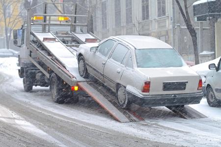 A tow truck towing a vehicle in Corona, NY