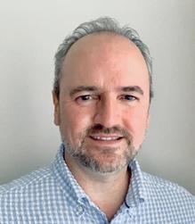 Close-up portrait of Dr. Gregory Lucas smiling.