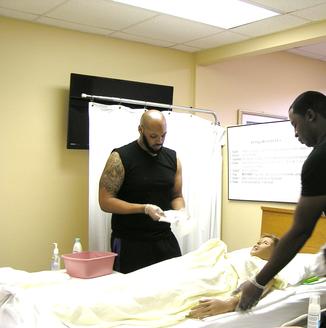 CNA Students and practice dummy
