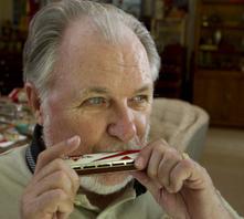 Harland Crain plays the harmonica