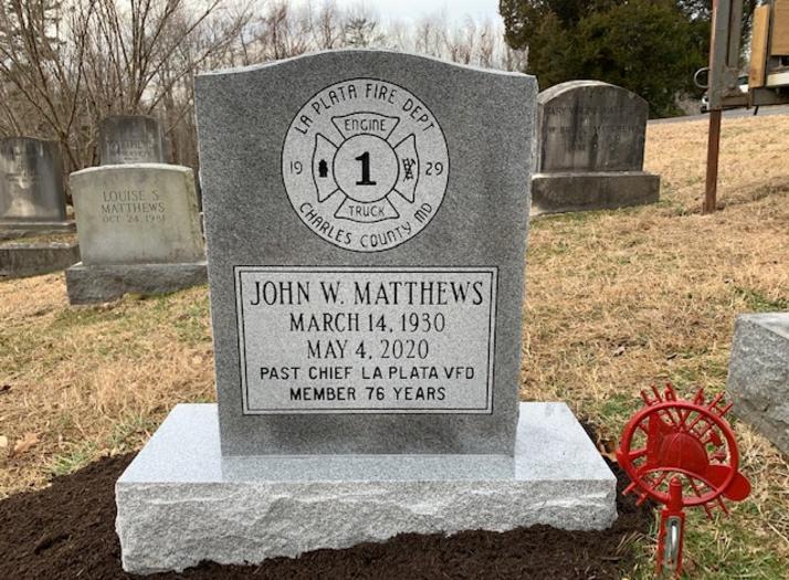 single upright headstone with firehouse design