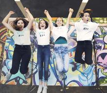 Four girls jumping in the air