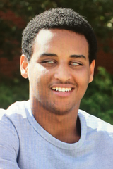 Head shot of Teme, smiling, looking at the camera