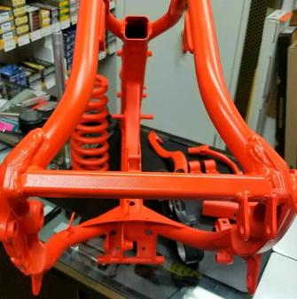 KTM motorcycle frame in Hunter Orange Cerakote "after"