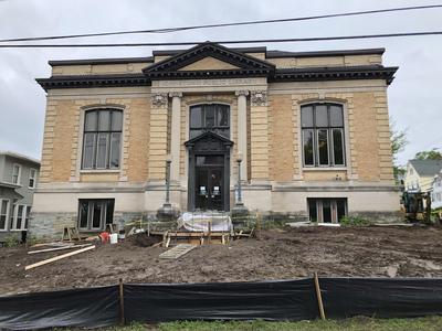 Front shot of building with cleared out dirt lawn