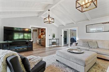 Photo of the interior of 28 Washington St in Novato. White walls and high ceilings with rafters. Wood floors and plenty of light.