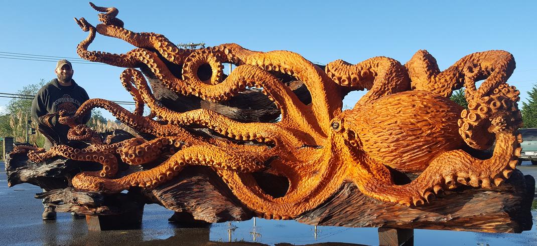 Man carved giant pacific octopus. Wood carved octopus. old growth redwood octopus. Carver in Gig Harbor, WA. Chainsaw artist, stump carver, large scale wood art.