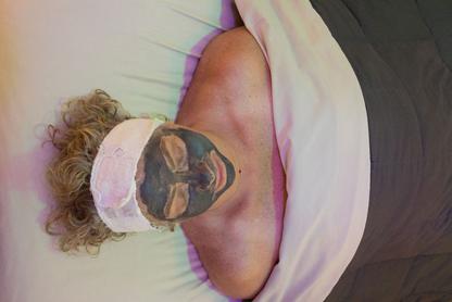 The facial and skincare room with a women having a mask applied by an esthetiation