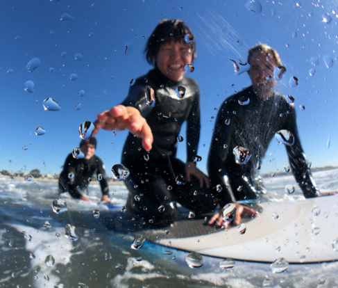 Blind Surfer Josh "the Jedi Loya teaching a surf lesson on the beach. Link to Waves4all Surf Page.