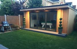 Modern cedar clad garden room with bifold doors, pool table and LED lighting in Langdon Hills, Essex built by Robertson Garden Rooms