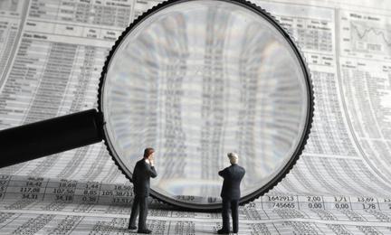 Magnifying glass looking at numbers