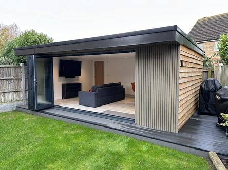 Beige slatted garden building with 5 panel bifold doors and bar