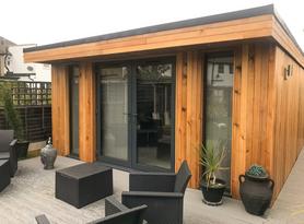 Modern cedar clad garden room with WC, shed, French doors and full length windows in Welling, Kent built by Robertson Garden Rooms