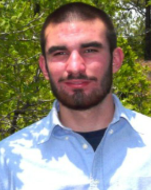 Outdoor picture of bearded Reed, smiling, looking at camera.