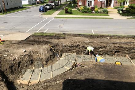 Poured concrete in forms with construction workers