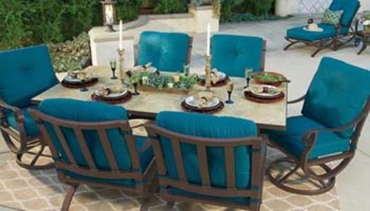 wrought iron dining table with chairs and blue chair cushions