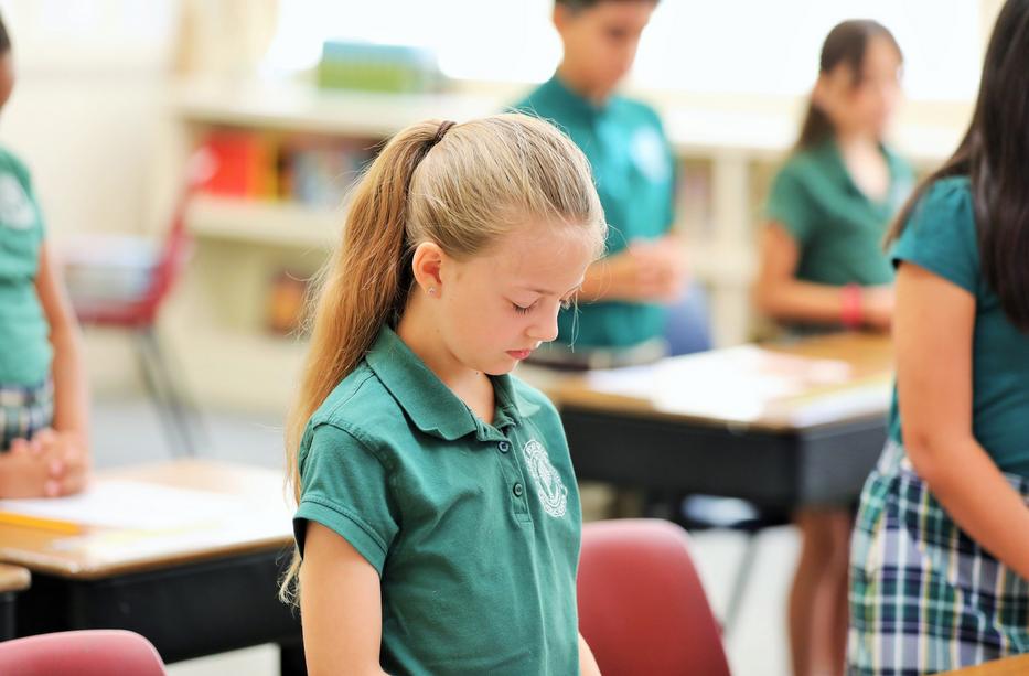 Girl praying at Hanford Catholic School