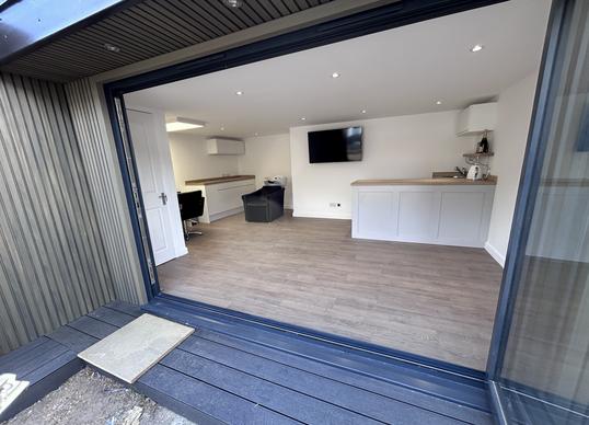 Large modern garden room with pool table and bar