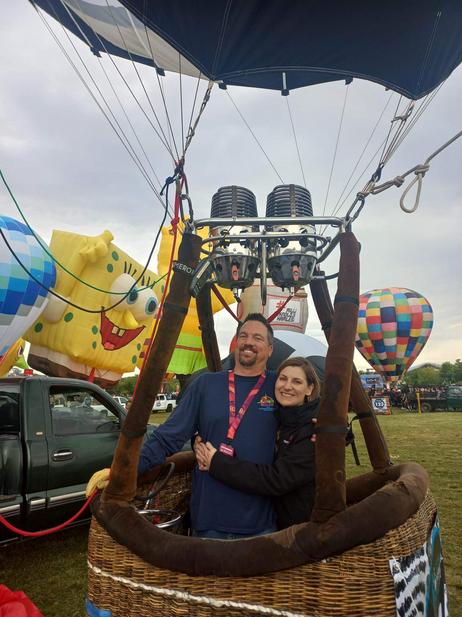 Adoption Profile Photo. Jessica and Nathan in a hot air balloon basket. They build and fly hot air balloons together.