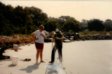 Man showing another how to setup a seine