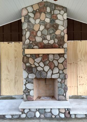 Isokern Fireplace Clad In Field Stone With Limestone Hearth.