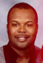 Head-shot of Wayne, smiling at cameraa