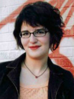 Amanda's senior picture, wearing glasses, smiling, looking at camera