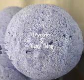 An image of a Lavender & Ylang Ylang Bath Bomb, featuring a bath bomb in soothing, calming color like lavender or soft purple
