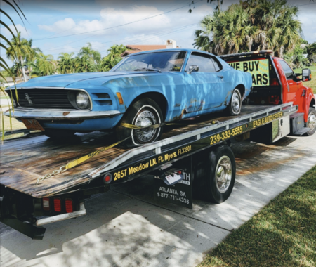 blue mustang being picked up