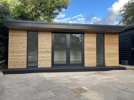 Modern garden room with French doors flanked by 2 full length windows