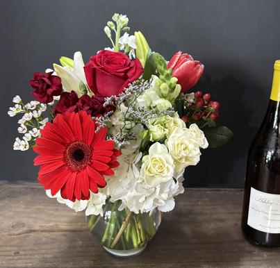 Hand-tied bridal bouquet with white ranunculus, brunia, billy balls, succulents, and other elements