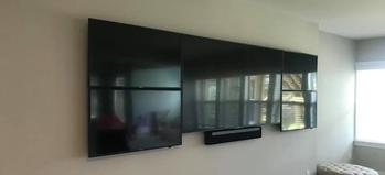 Three TVs mounted on a wall with Sonos Playbar mounted below, Flat Screen TV mounting in Charlotte NC and Fort Mill SC, Carolina Custom Mounts
