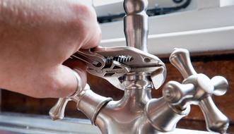 handyman fixing a faucet
