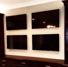 4 flat screens on 1 wall, multiple tvs mounted on same wall, professional flat screen tv mounting in charlotte