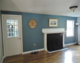 Newly painted room with a fireplace.