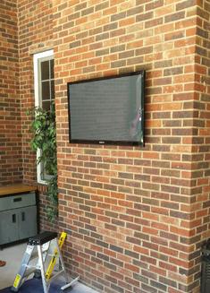 Flat Screen TV mounted on brick outside porch, Carolina Custom Mounts, Charlotte NC best professional TV mounting service