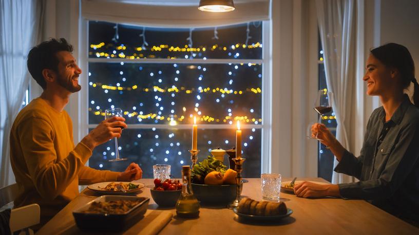 Happy couple having candle light dinner